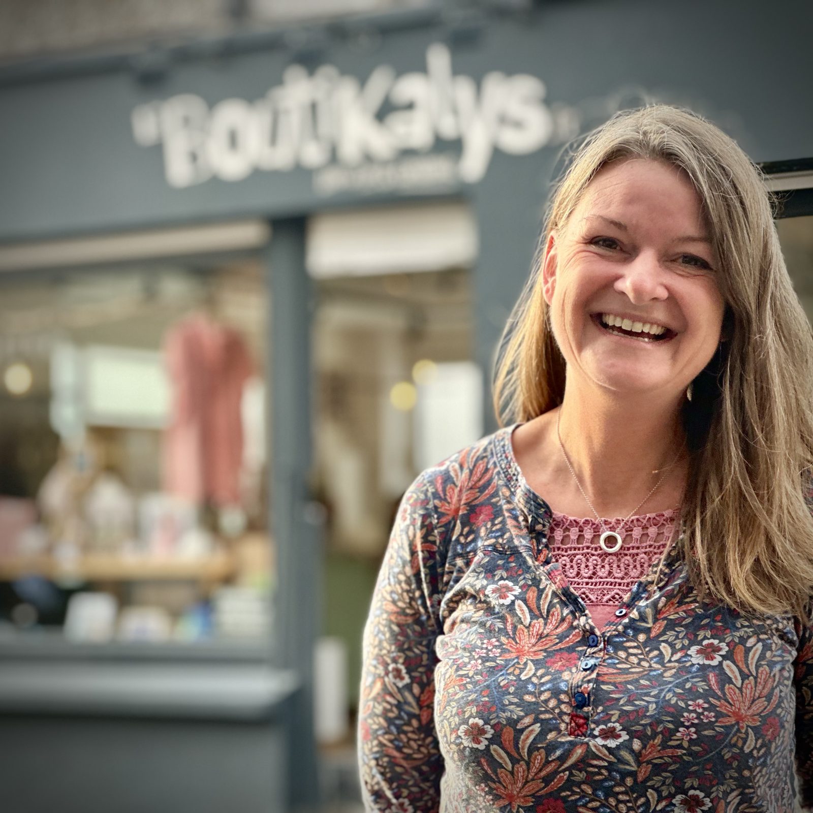 Sarah, souriante devant la vitrine de Laboutikalys, 17 rue Jean Jaurès à Oignies